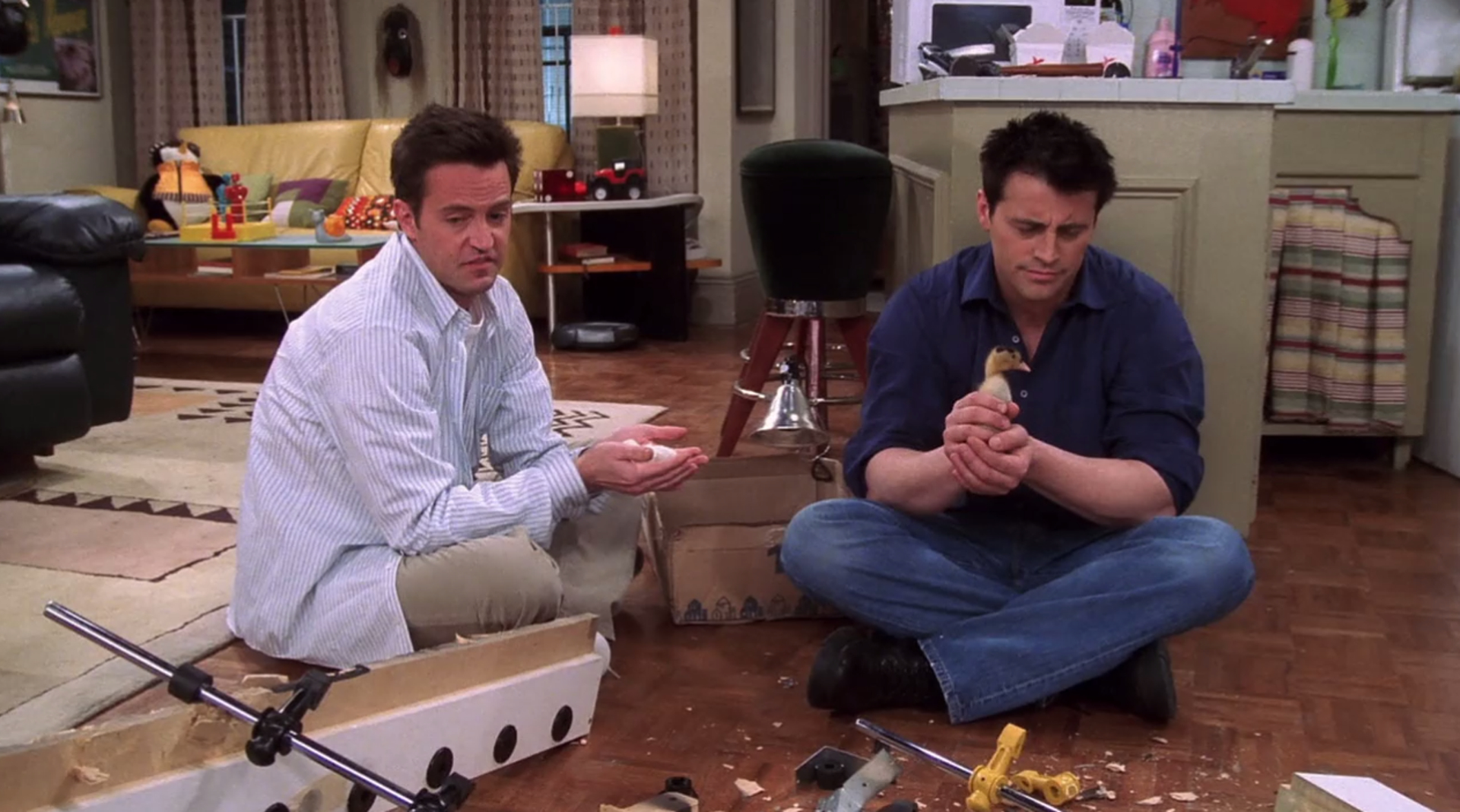 Joey and Chandler sitting on the floor in Friends.