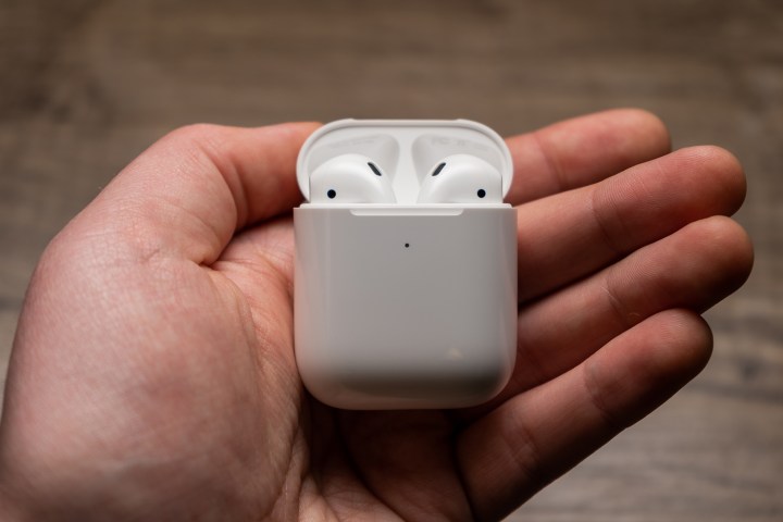 Apple AirPods case on a hand.