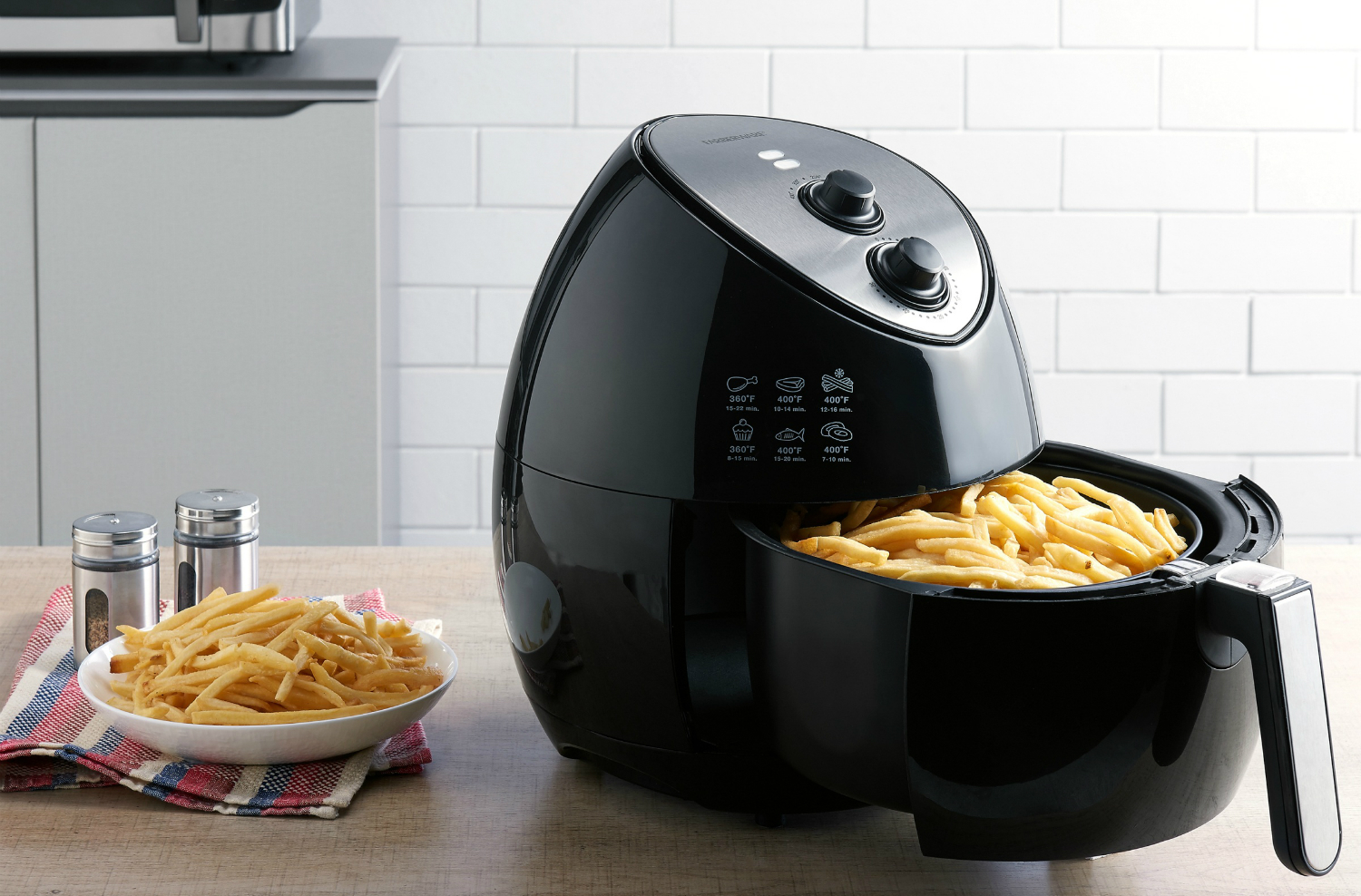 The 3.2-quart Farberware air fryer with fries in the open basket.
