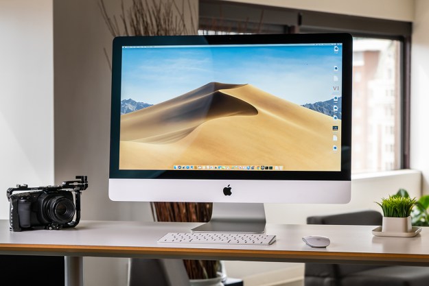 An Apple iMac from 2019 placed on a desk. The macOS Mojave operating system is on its display.