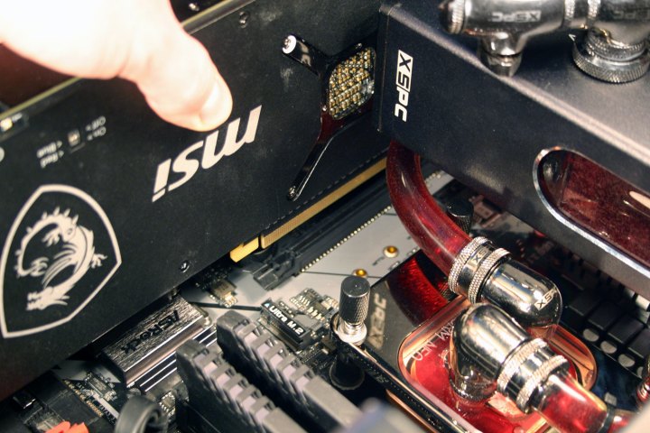 A graphics card being added to a computer.