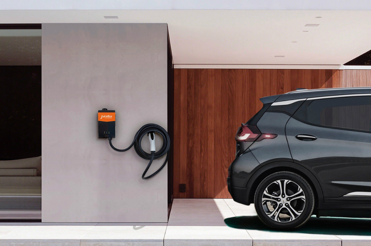 JuiceBox Pro 40 EV charger installed in a garage next to a car.