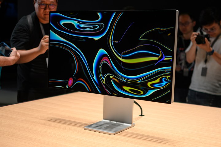 Members of the press photograph an Apple Pro Display XDR at WWDC 2019.