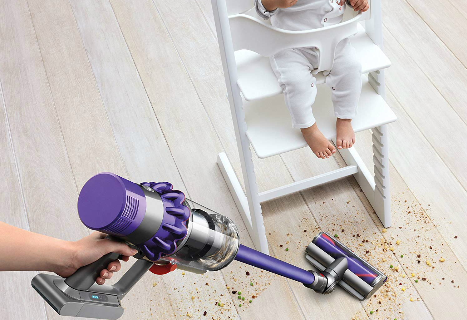 The Dyson Cyclone V10 Animal cordless vacuum cleaning a mess made by a baby.