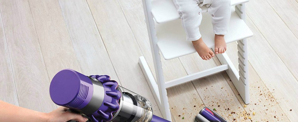 The Dyson Cyclone V10 Animal cordless vacuum cleaning a mess made by a baby.