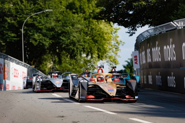 tech news The Formula E Swiss E-Prix with a car racing in the street.