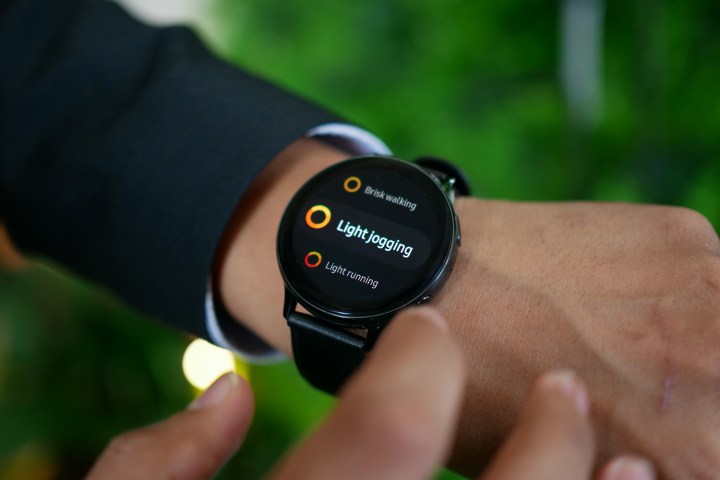 Samsung Galaxy Watch Active 2 on a wrist displaying an activities menu.
