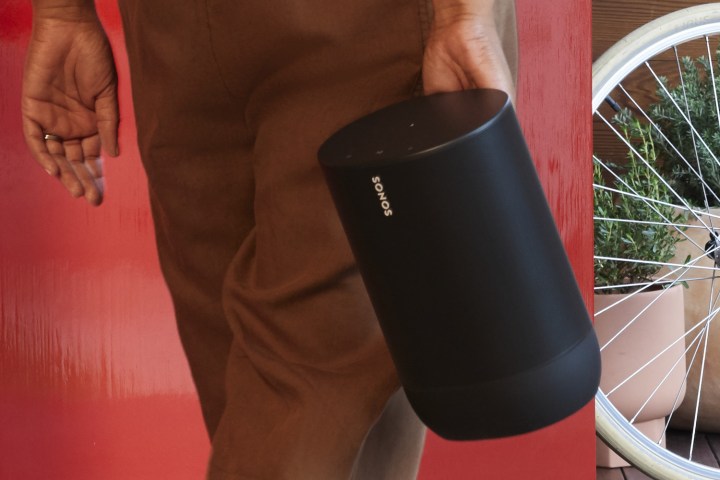 The Sonos Move being carried by a person.