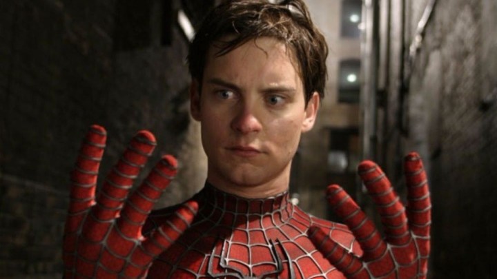 Mask-less Spider-Man looking at his hands with confusion in Spider-Man 2.