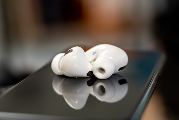 AirPods Pro laying on the back of a phone.