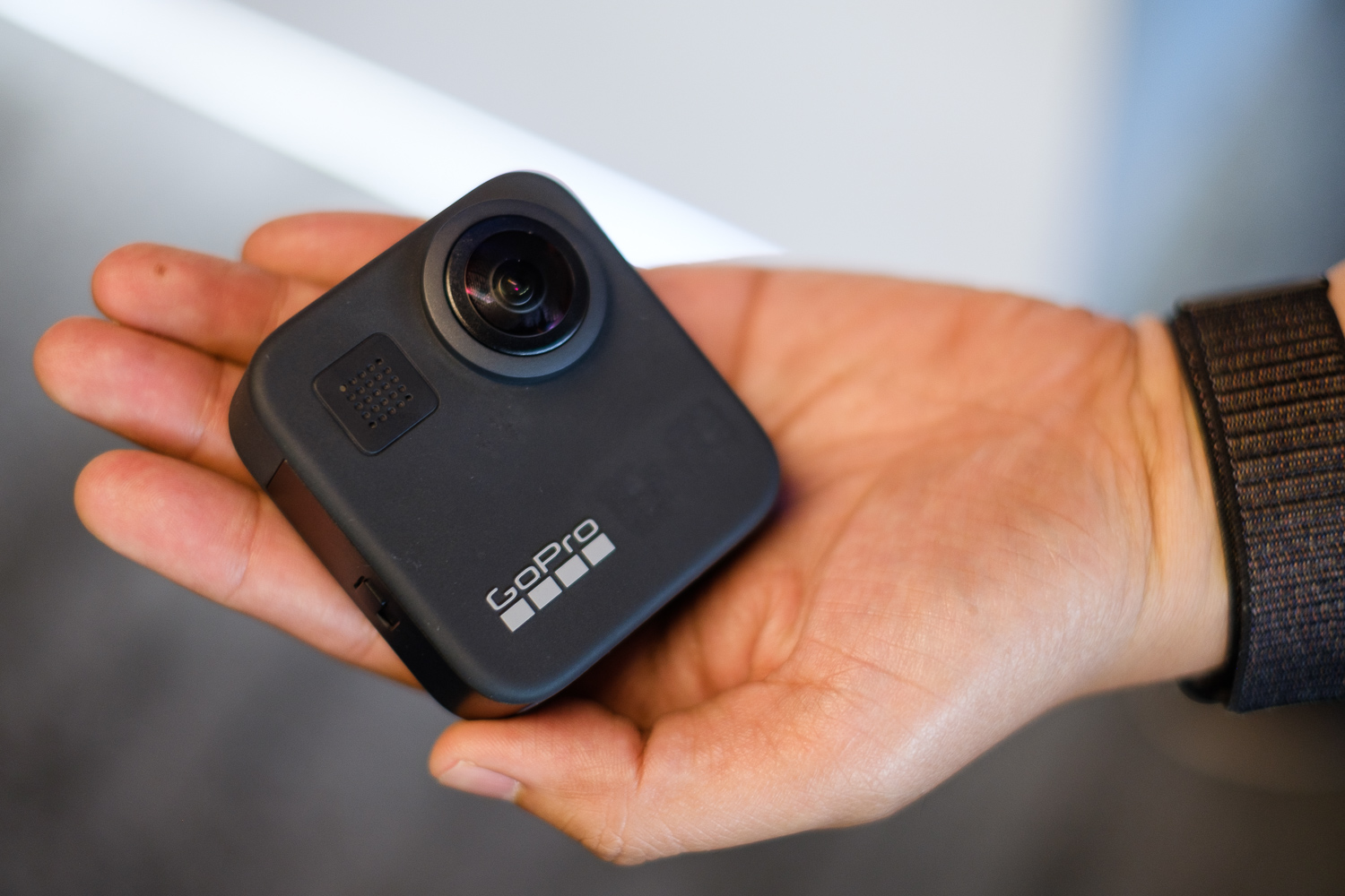 GoPro Max 360 camera in hand, front