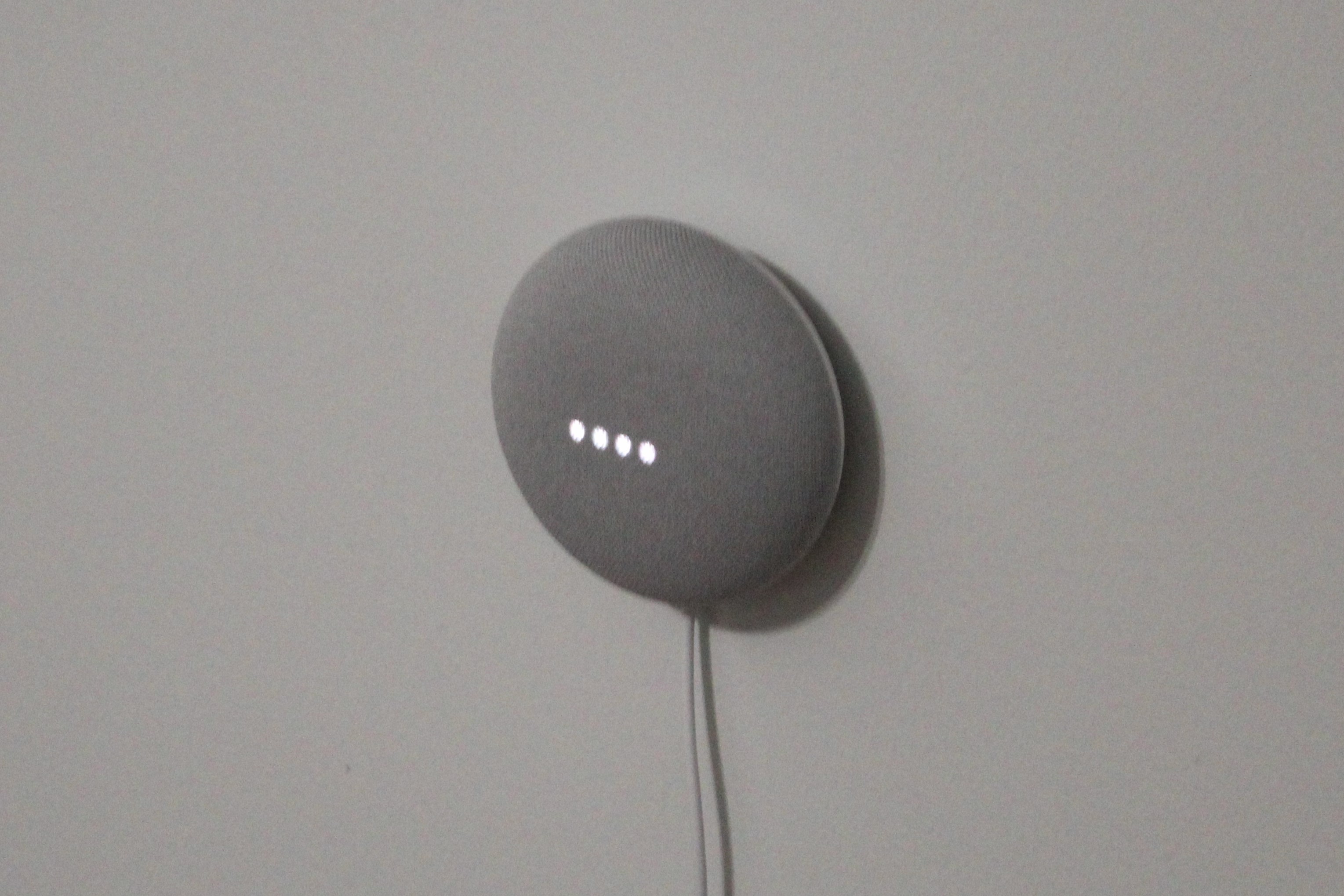 Google Nest Mini on a wall.