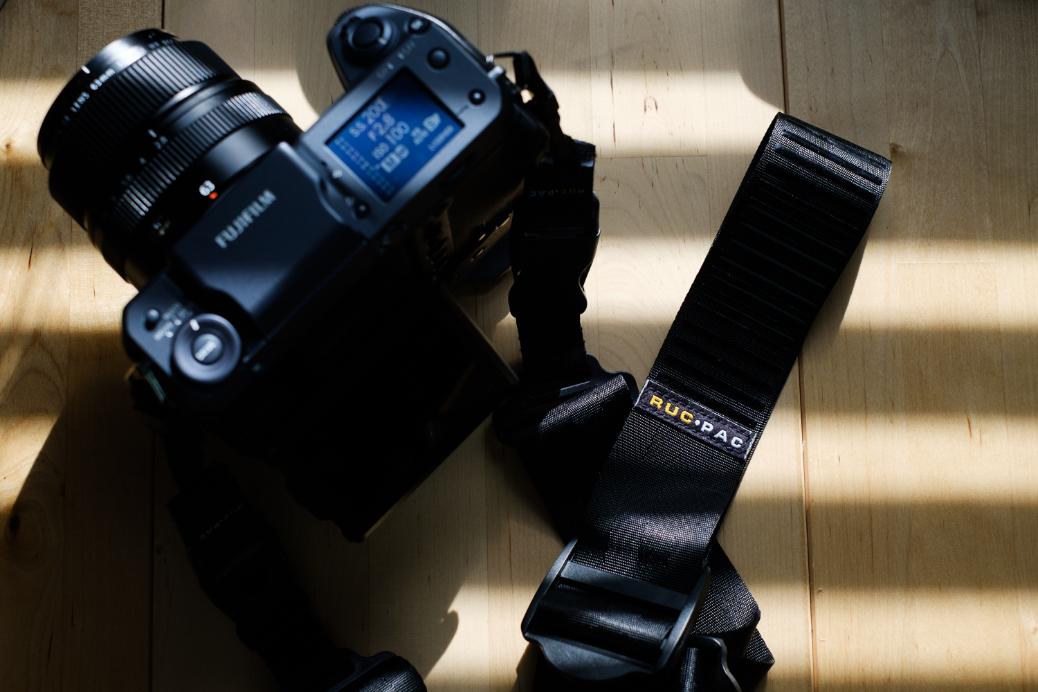 RucPac Slide camera strap attached to Fujifilm GFX 100 camera