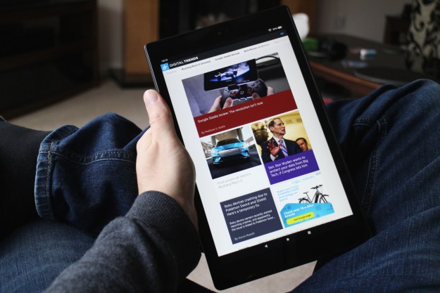 The Amazon Fire HD 10 tablet in hand.