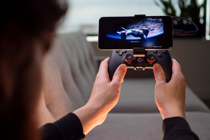 A gamer plays Destiny 2 on a phone via Google Stadia.