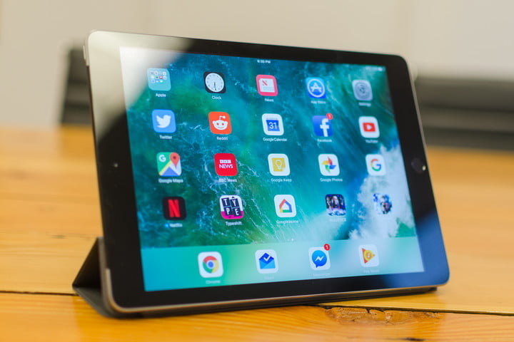 Apple iPad 9.7 on a table surface.