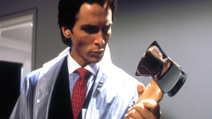 Christian Bale looking at an axe in American Psycho.