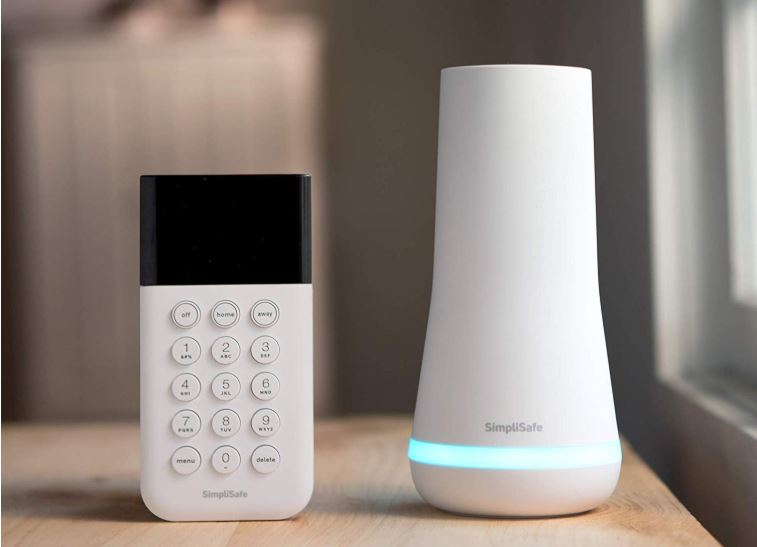 The SimpliSafe keypad and base sitting on a table.