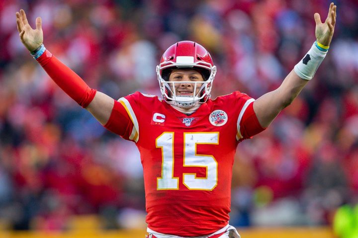 Patrick Mahomes holds his arms up.