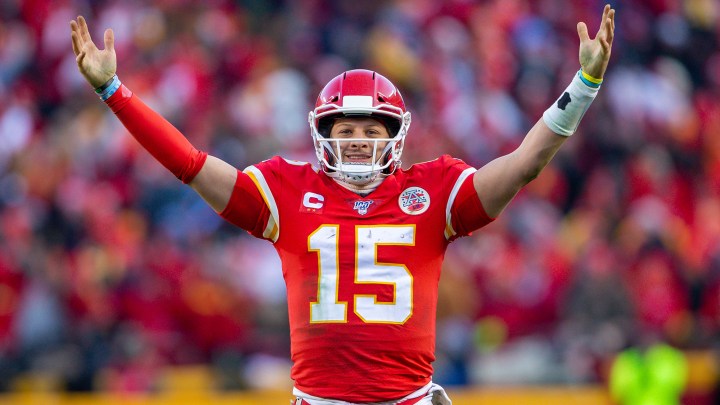 Patrick Mahomes holds up his arms.