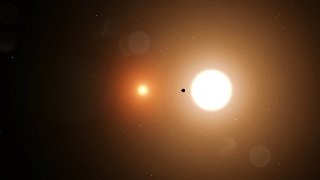 An illustration of planet TOI 1338 b silhouetted by its host stars.