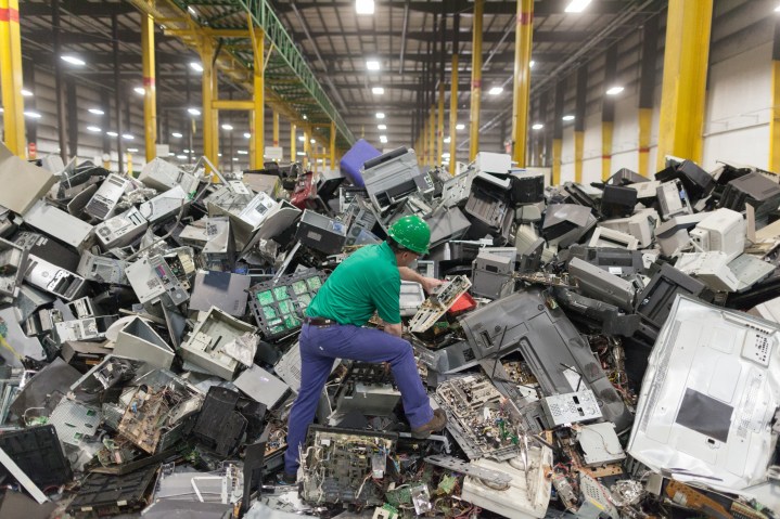 A man standing in e-waste