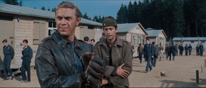 Two prisoners stand in the yard of a camp in The Great Escape.