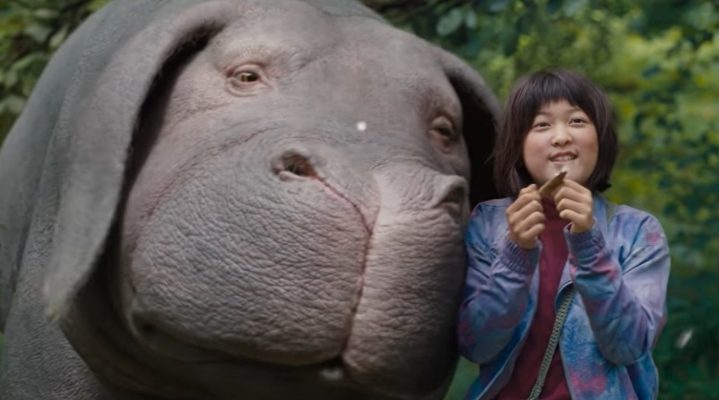 A girl and Okja in "Okja."