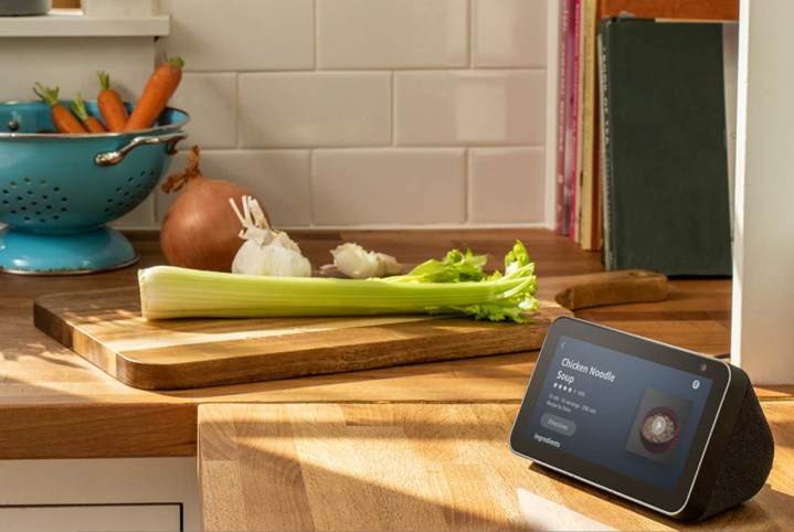 Echo Show 5 in the kitchen beside vegetables.