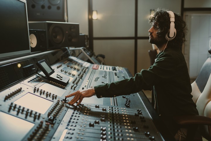 Sound engineer at a studio mixing board.