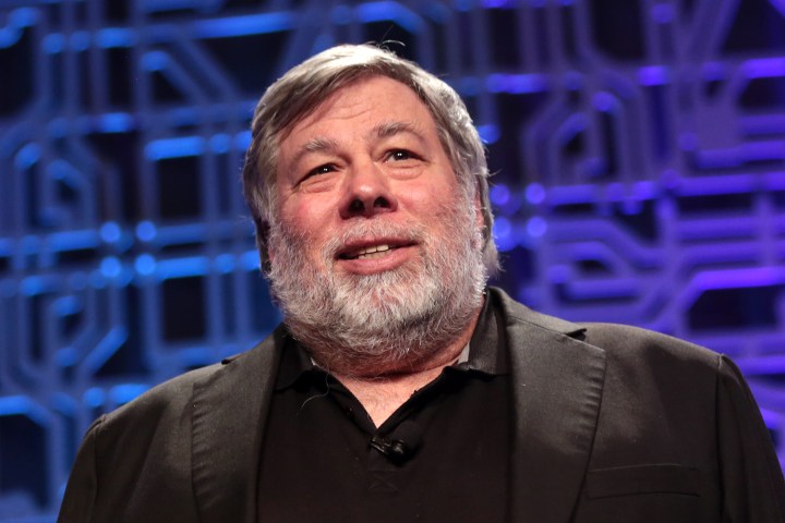 Apple co-founder Steve Wozniak stands against a dark background.