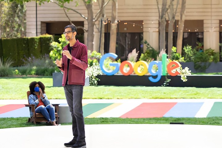 Sundar Pichai se tient devant un logo Google à Google I/O 2021.