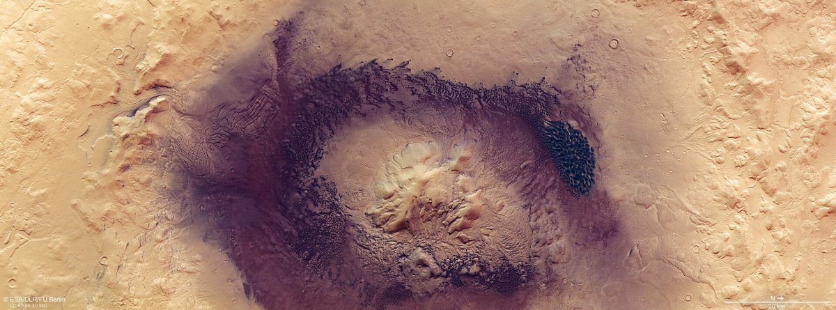 Known for its wide swathes of rippling, textured, gently sloping dunes, Mars’ Terra Sabaea region is home to many fascinating geological features – including the prominent Moreux crater, the star of a new image from ESA’s Mars Express.