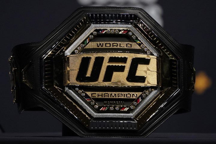 A UFC championship belt sitting on a table.