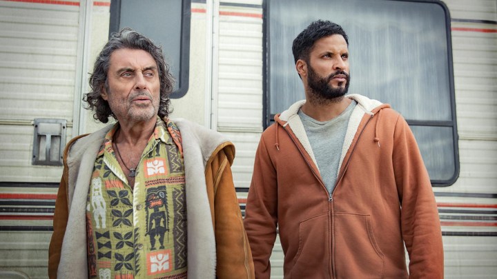 Ian McShane and Ricky Whittle as Mr. Wednesday and Shadow Moon looking in the same direction in the show American Gods.