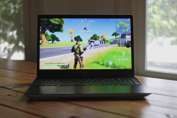 Dell G5 SE gaming laptop review photo. A Dell G5 SE gaming laptop sitting on a wooden table.