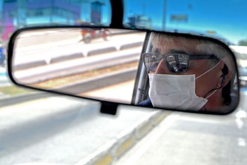 A driver wearing a face mask.