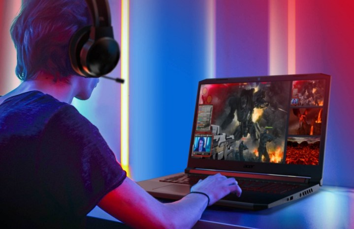 A man playing on an Acer Nitro 5 gaming laptop.