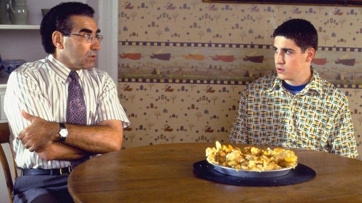 A father and son sit at table in American Pie.