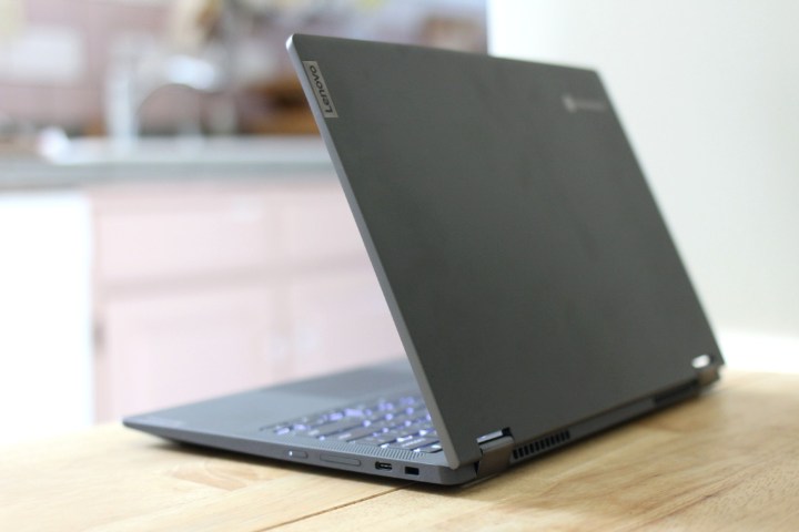 The Lenovo Chromebook Flex 5 from the side, partially closed, on a wooden counter.