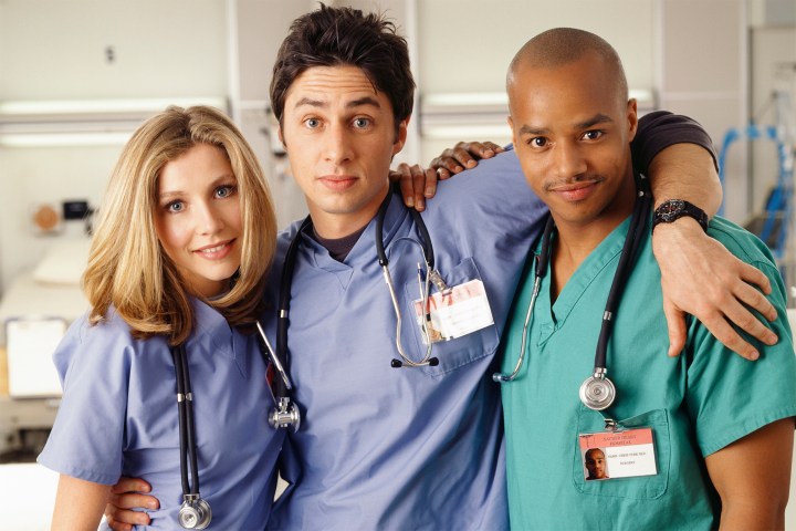 Three doctors pose in Scrubs.