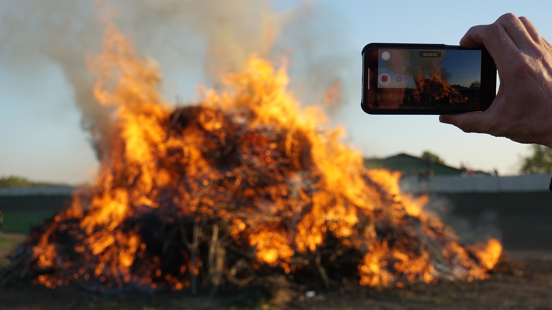 An iphone filming a bonfire. 