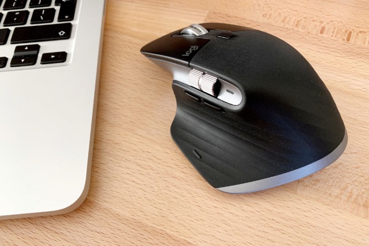 The Logitech MX Master 3 mouse beside MacBook.