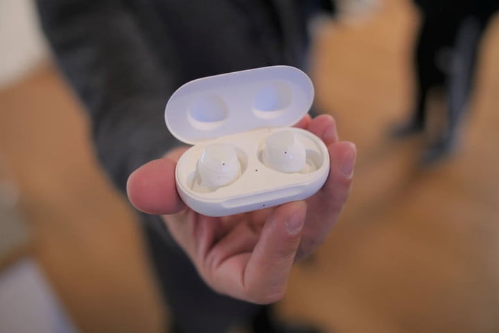 A person holding the Samsung Galaxy Buds 2 in a case.