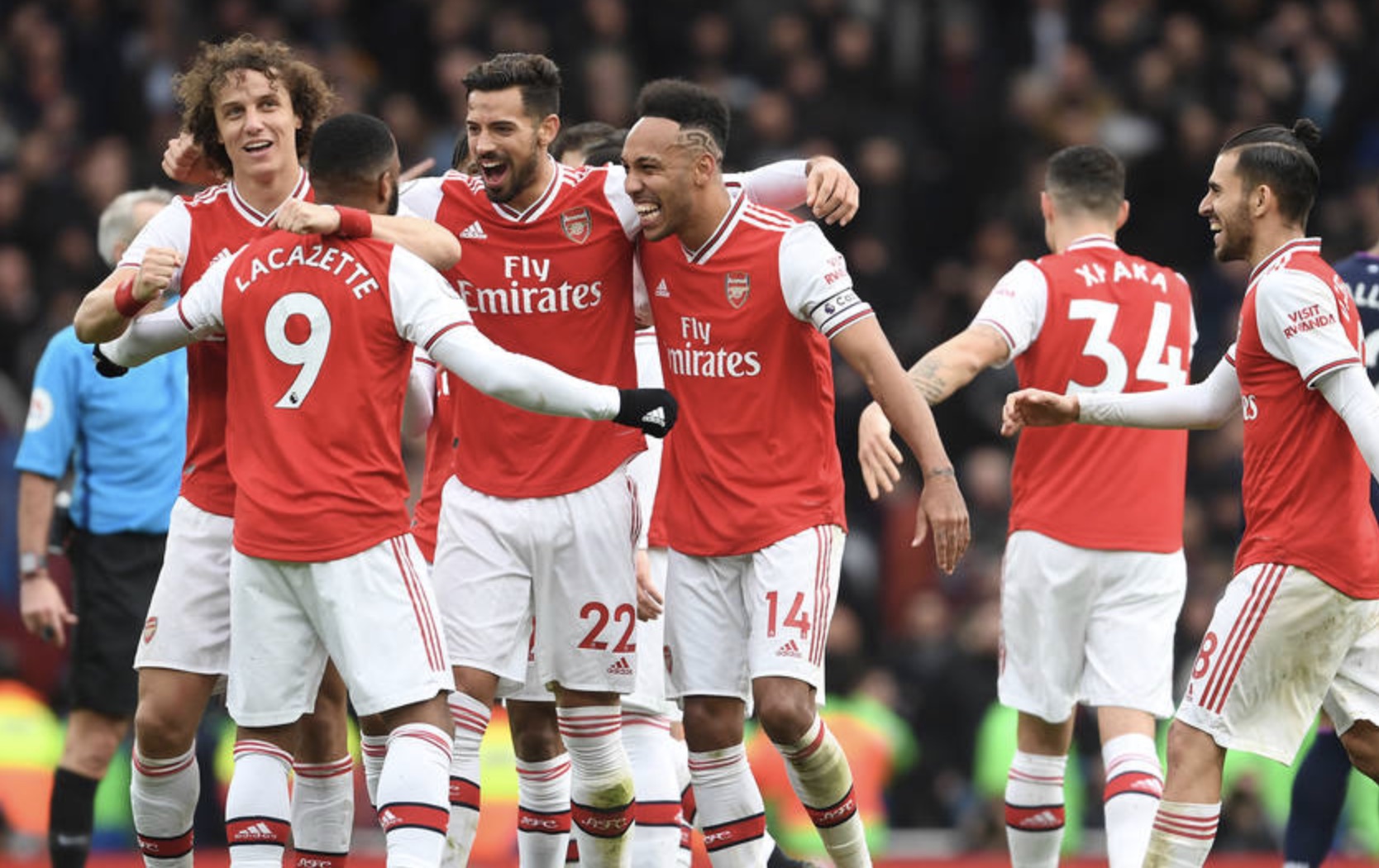Arsenal FC players celebrating on the field.