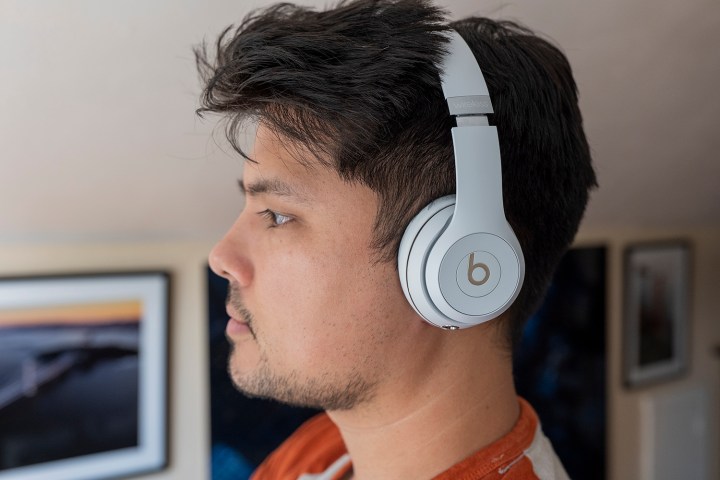 A side angled view of a man wearing Beats Solo3 headphones.