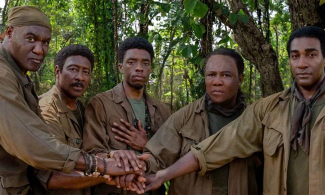 Five Black soldiers joining hands and looking at the camera in Spike Lee's Da 5 Bloods.