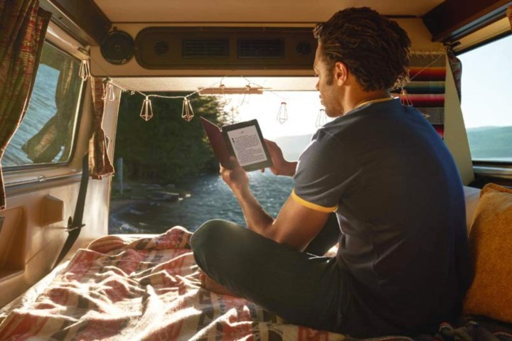 Guy in van with Kindle Paperwhite