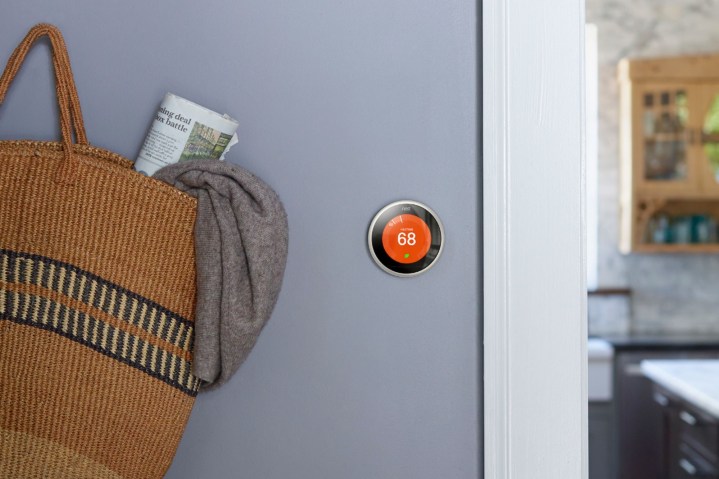 The Nest Learning Thermostat mounted on the wall.