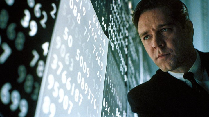 Russell Crowe olha para números em uma parede em Uma Mente Brilhante.